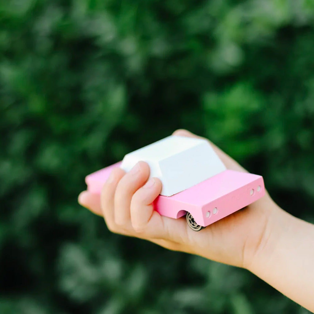Candylab Suburbia Pink Sedan in the hand of a child
