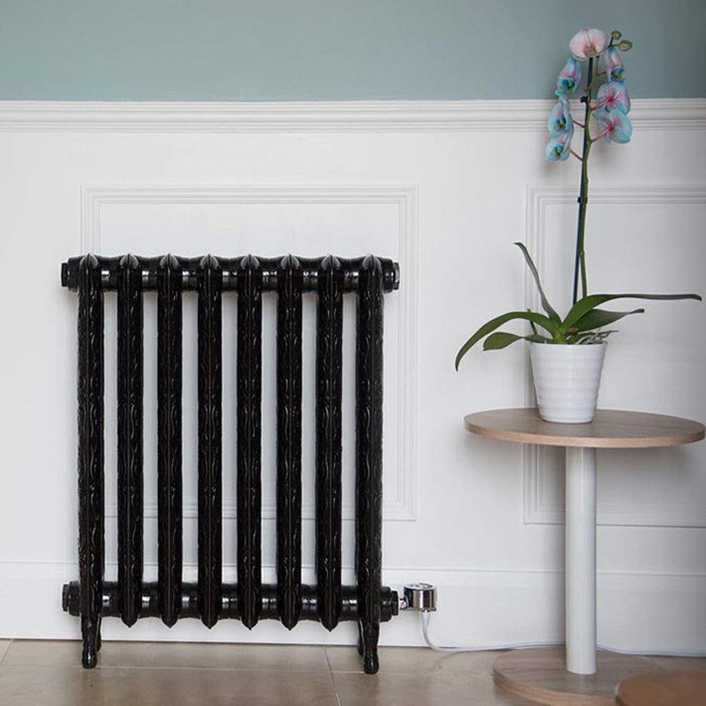 Electricast Art Nouveau 8 Section Cast Iron Radiator in Black against a white panelled wall. 