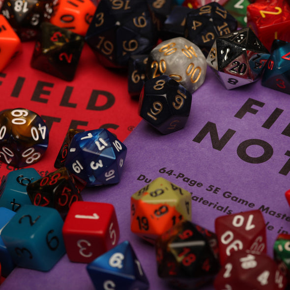 Field Notes 5E Gaming Journals covered in dice