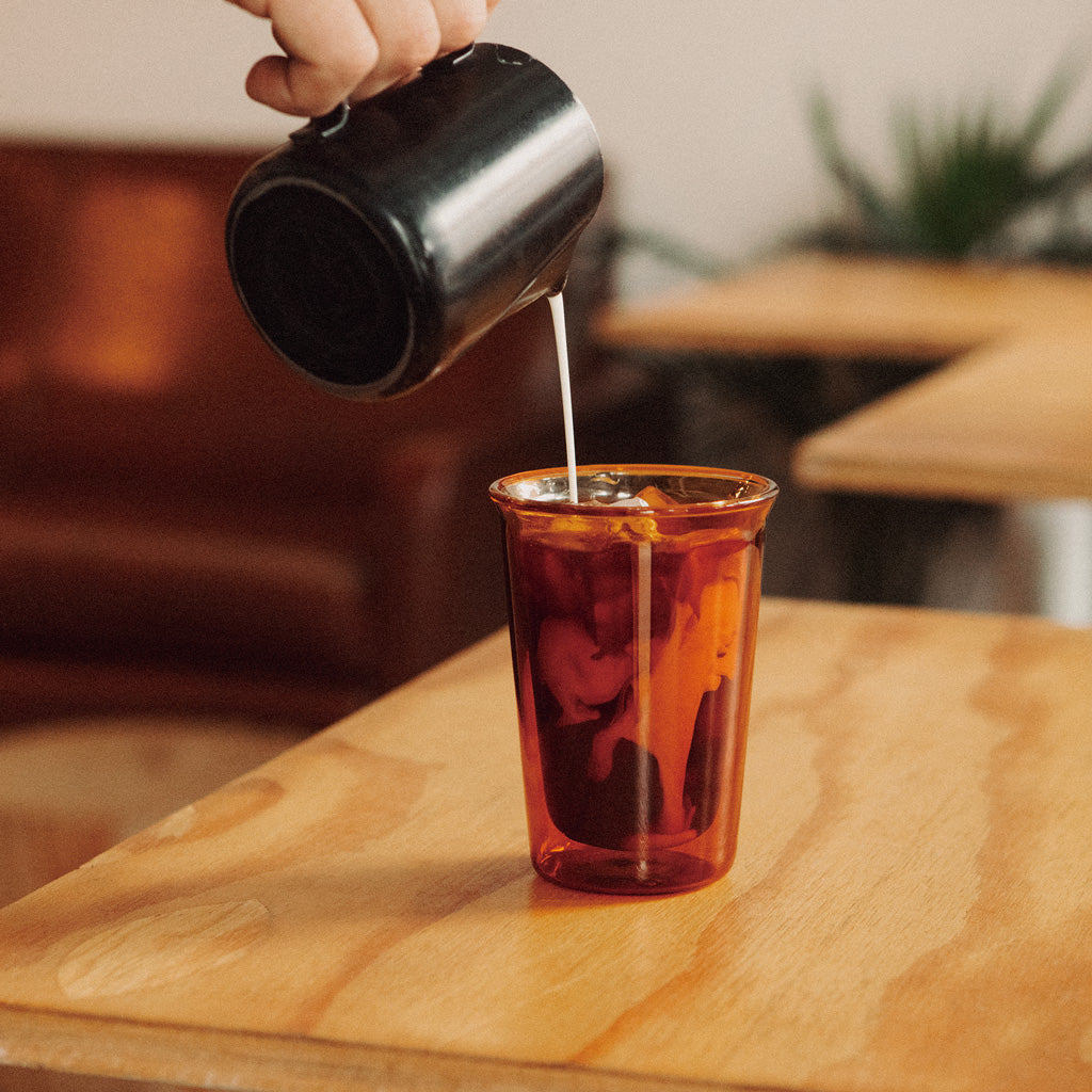 Kinto Cast Amber Glass Iced Coffee pouring