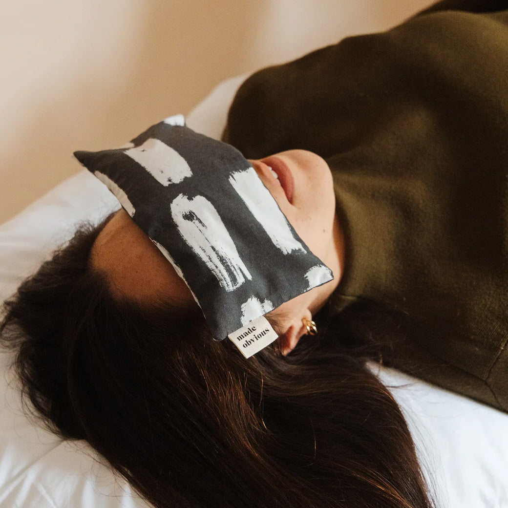 Made Obvious Labour of Love Eye Pillow in Mark Making on a woman's face relaxing. 