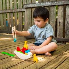 Plan Toys Balancing Boat Child playing on deck