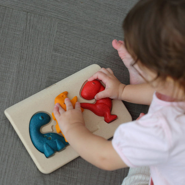 Child playing with Plan Toys Dino Puzzle