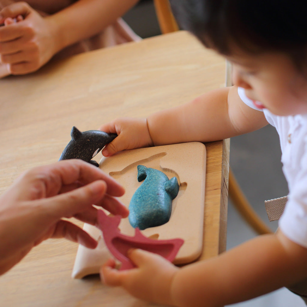 Child playing with Sustainably produced Sea Life Puzzle by Plan Toys