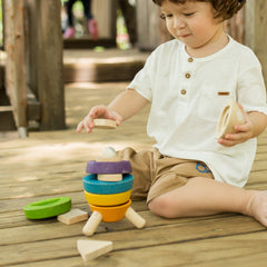 Stacking Rocket by Plan Toys being played with by a boy