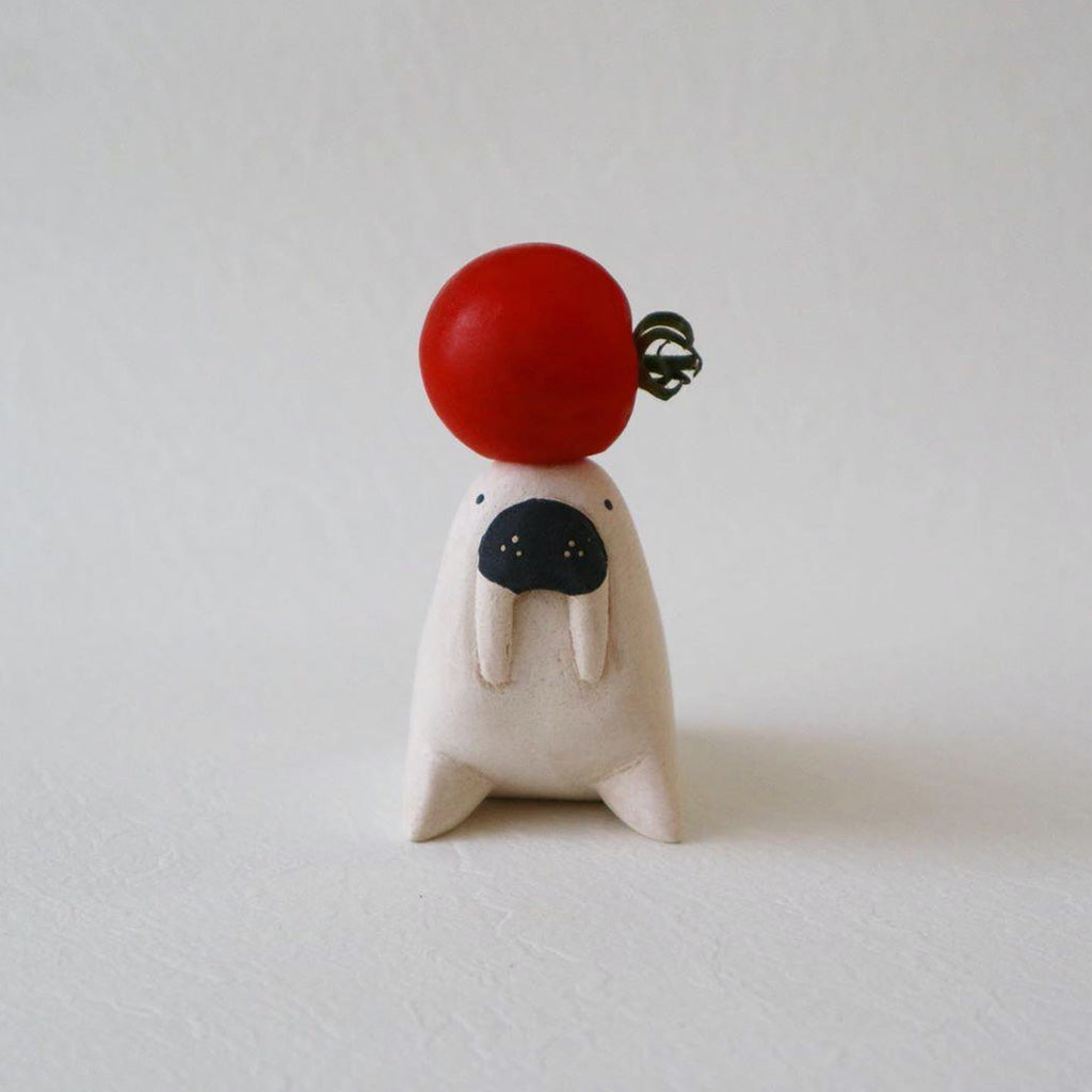 T-Lab Pole Pole Walrus with a tomato balancing on it's head