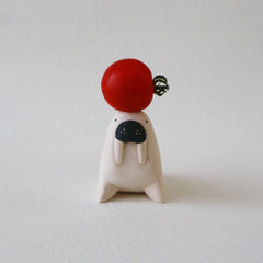 T-Lab Pole Pole Walrus with a tomato balancing on it's head
