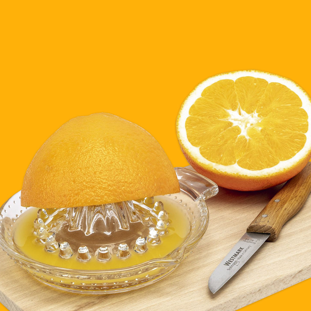 Westmark Citrus Juicer Press 30ml with orange on chopping board
